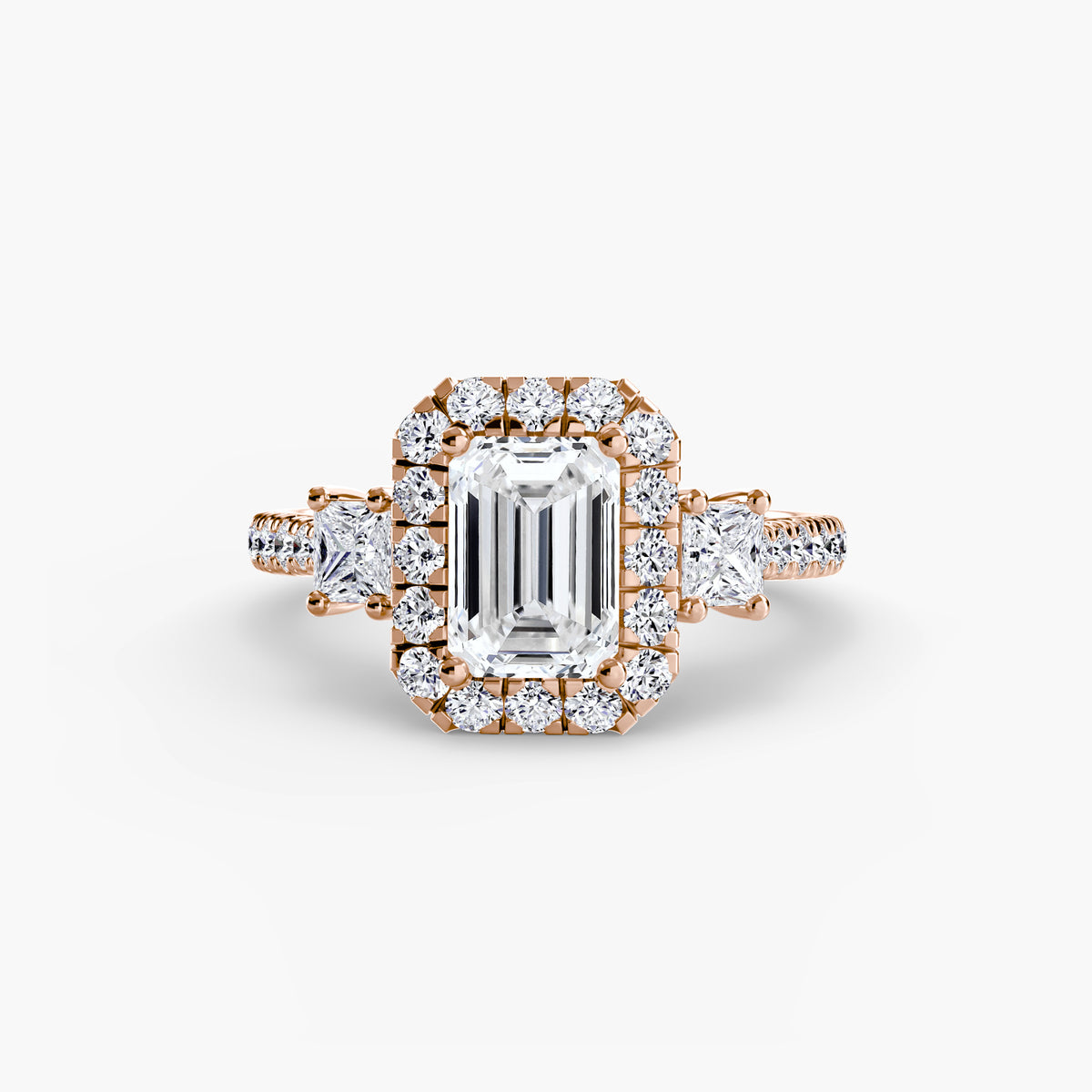 Guinevere Emerald Three-Stone Halo in rose gold